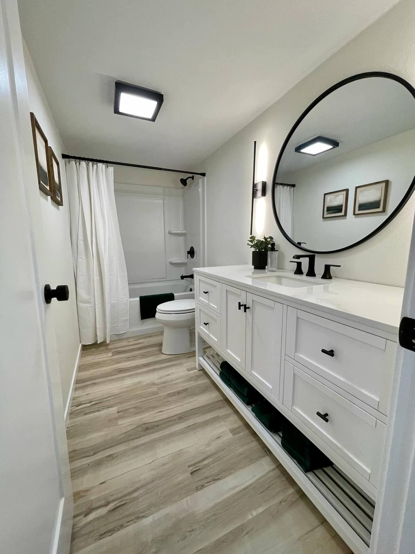 A luxurious bathroom features a spacious shower, a toilet, and a vanity with mirror above.