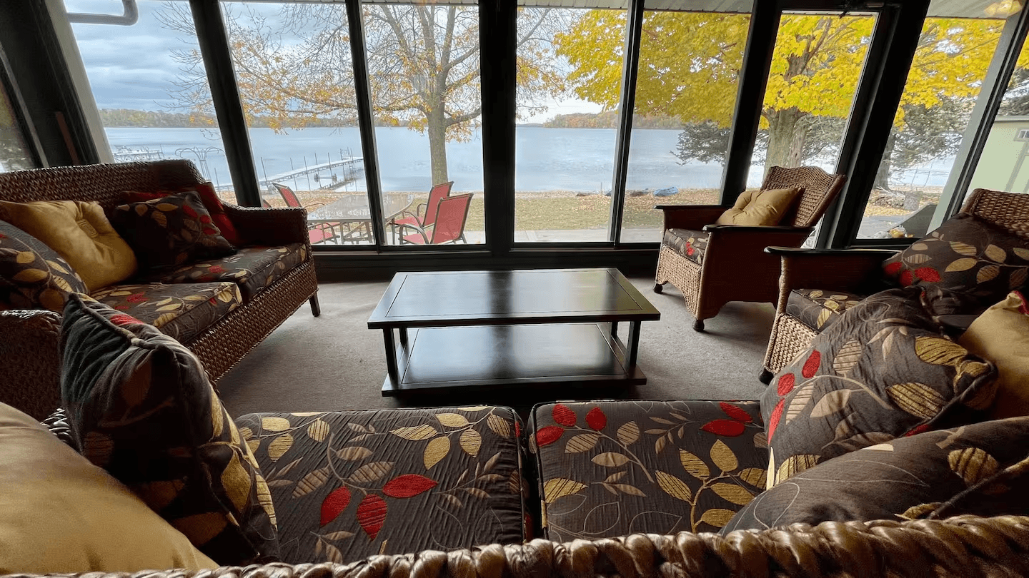 Spacious seating area in four-season room with gorgeous lake views.